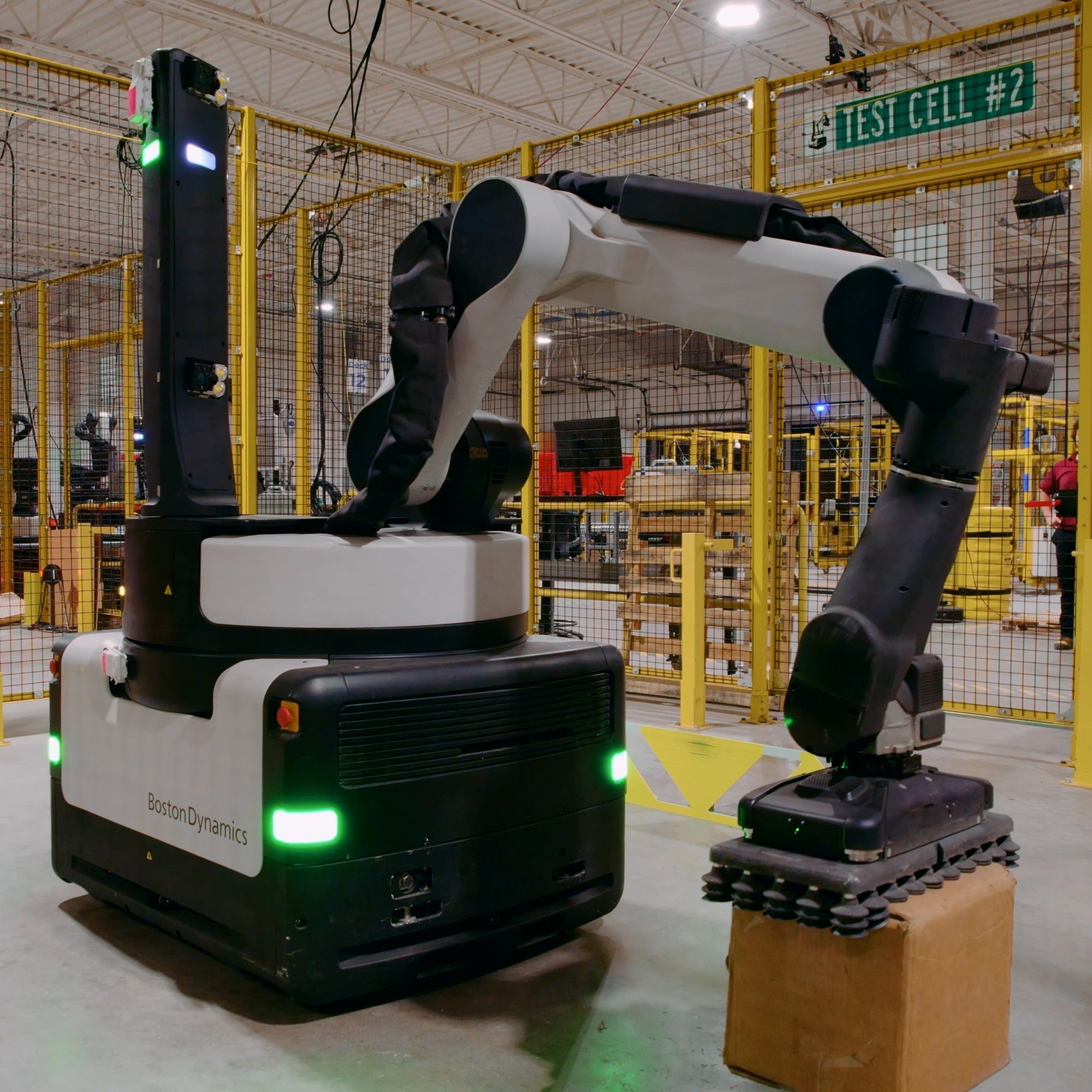 Stretch in a test cell picks a box from the floor